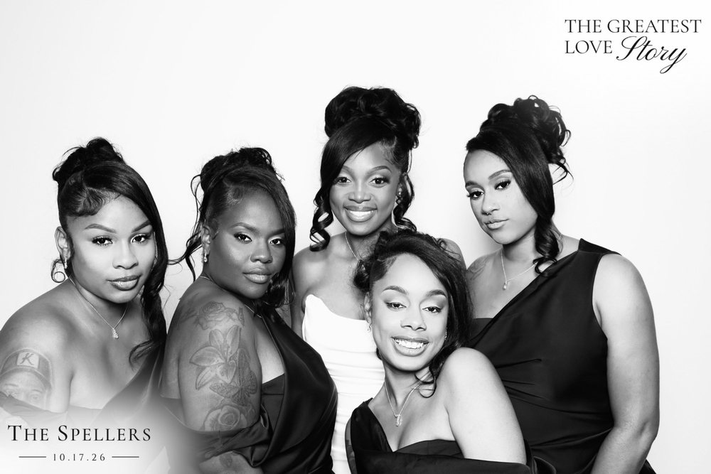 Makima with friends in black gowns at a black-and-white wedding photo booth at the Signet Center in Chesapeake