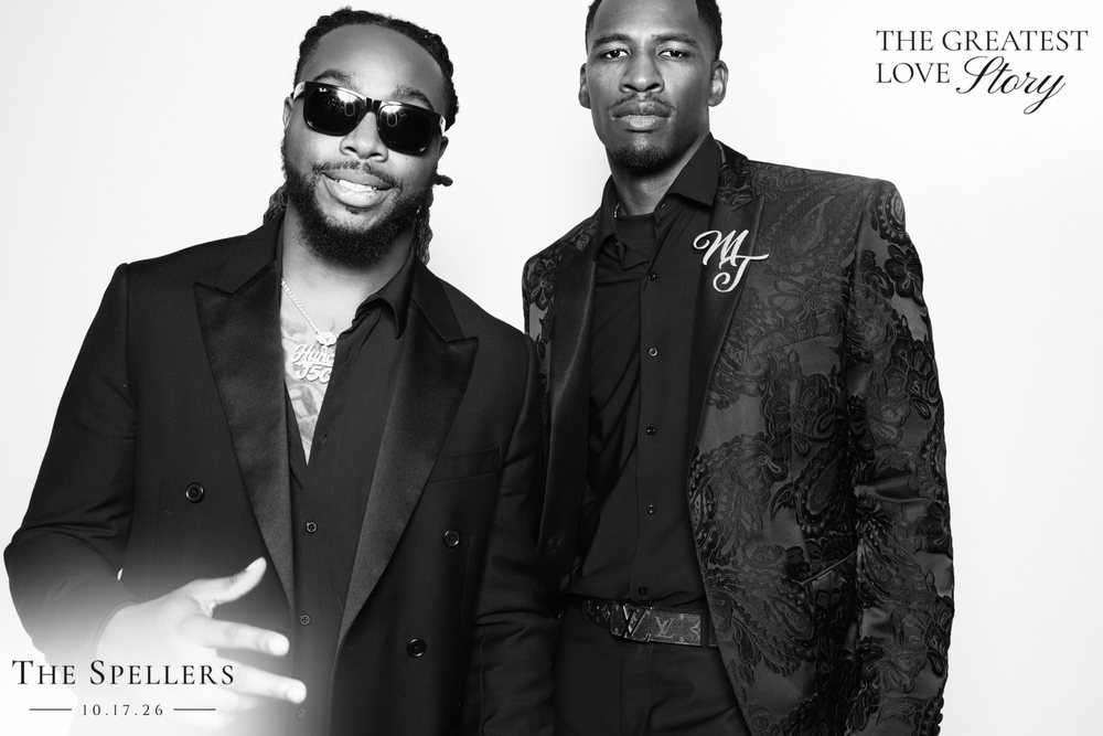 Trequan and a friend in black suits at a black-and-white wedding photo booth at the Signet Center in Chesapeake