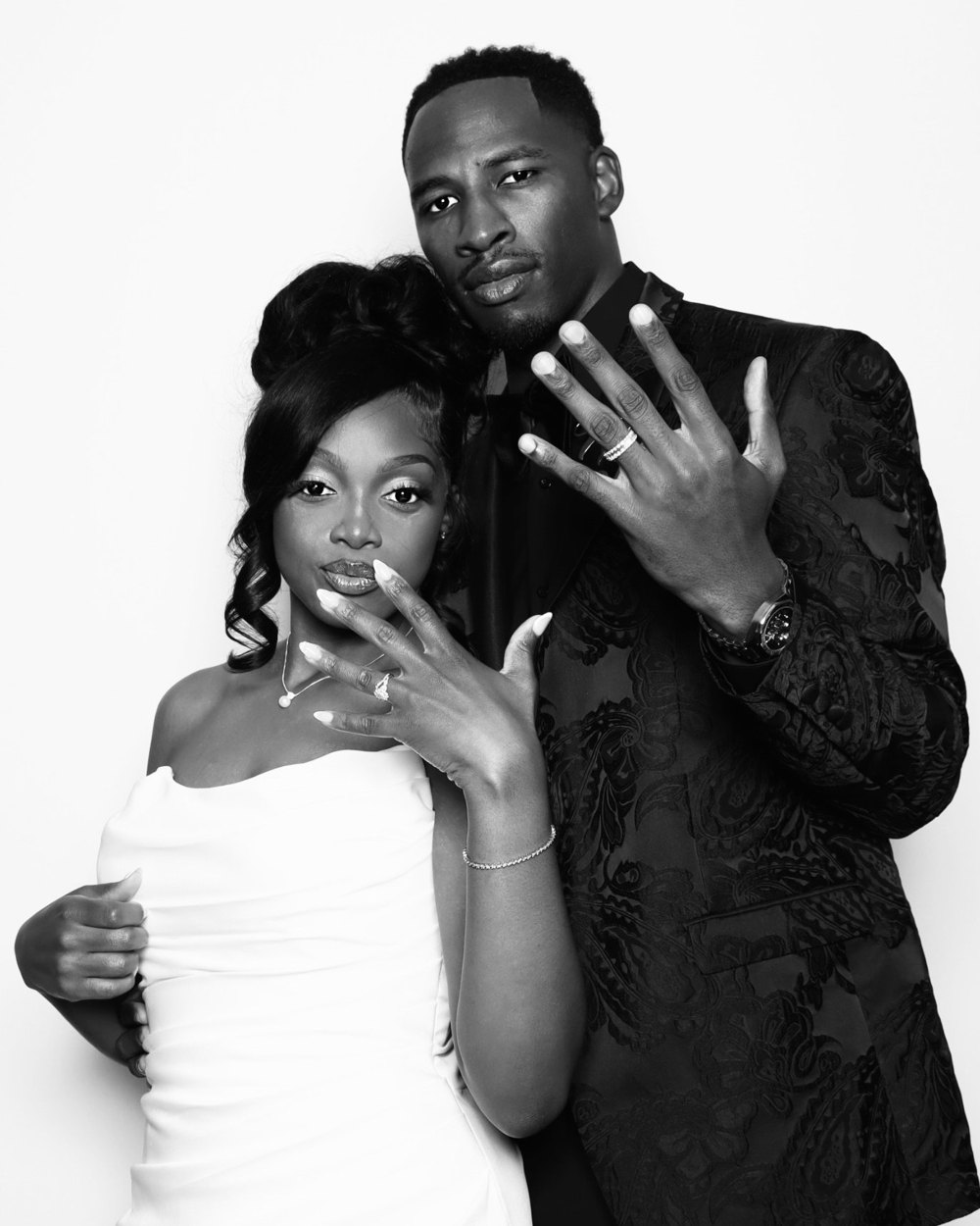 A newlywed couple showing off their wedding rings at a black-and-white DSLR wedding photo booth at the Signet Center in Chesapeake