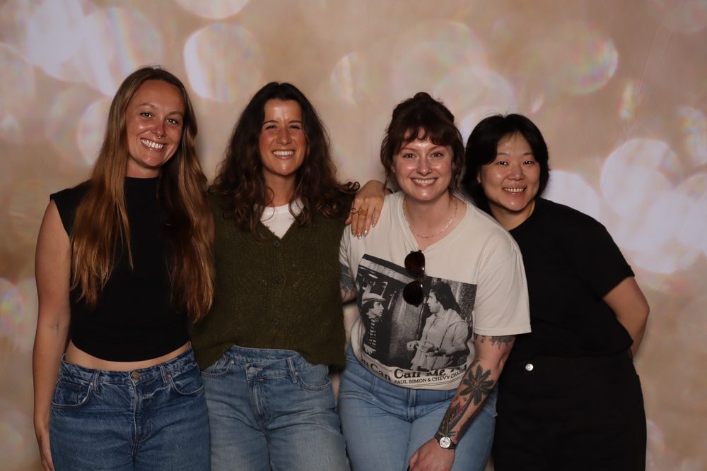 Four coworkers posing at a corporate event photo booth in San Francisco