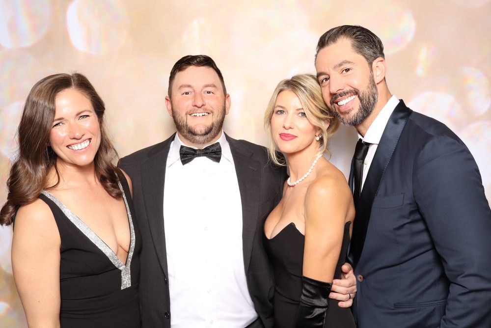 Two couples in formal wear at the VBSPCA gala photo booth in Virginia Beach