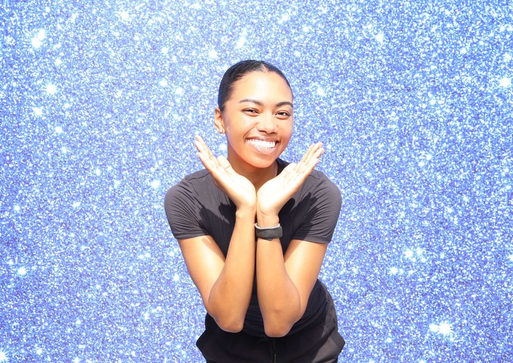A guest striking a playful pose at a Topgolf corporate event photo booth in Virginia Beach