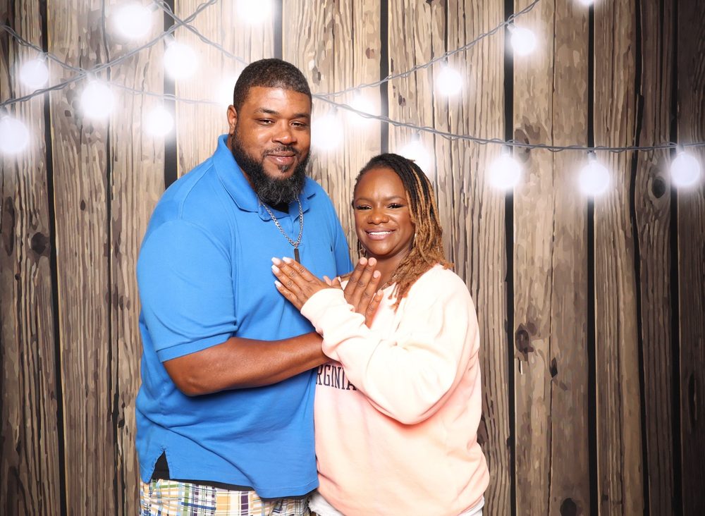 A couple posing at a Southern soul party photo booth in Virginia Beach