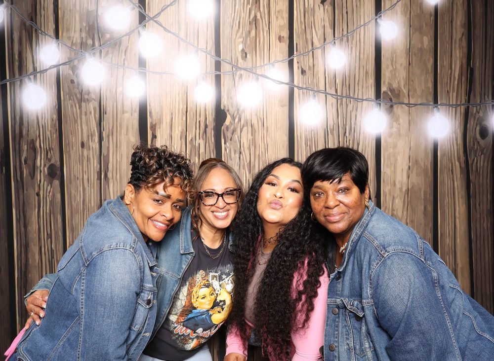 Four friends in denim on the Southern night at the Beats on the Beach photo booth in Virginia Beach