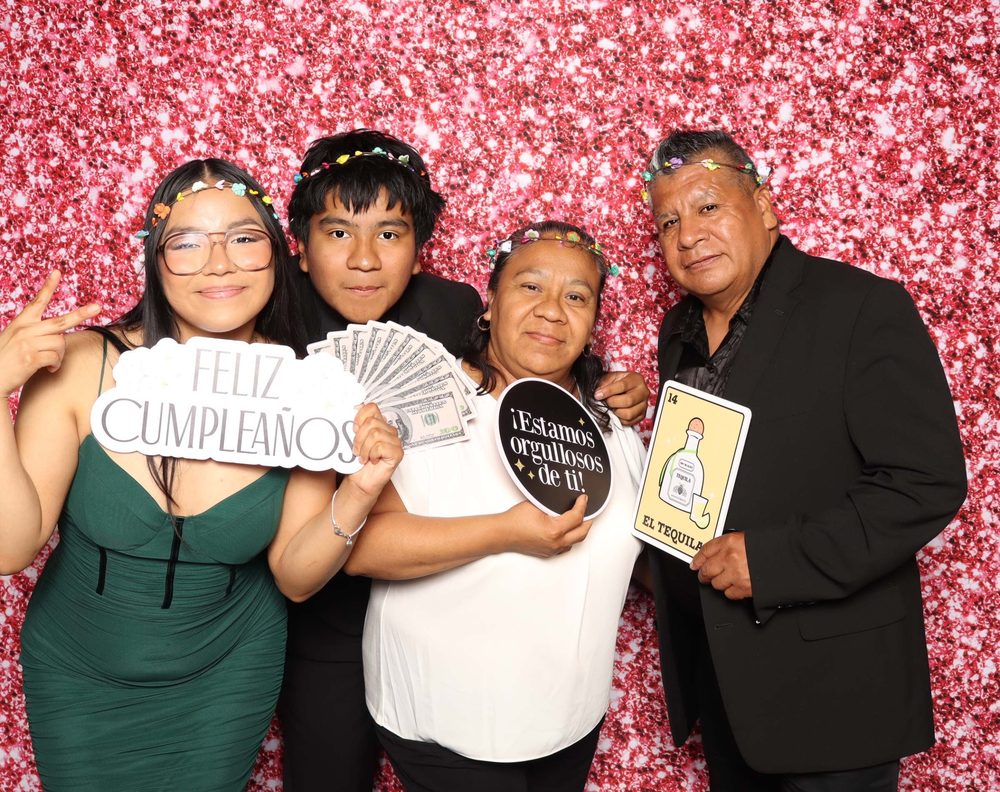 Family members posing together at a quinceañera photo booth in Perth Amboy