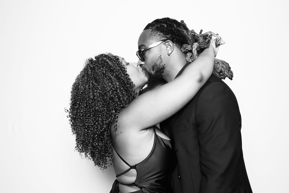 A couple wrapped in a kiss at a Chesapeake wedding photo booth