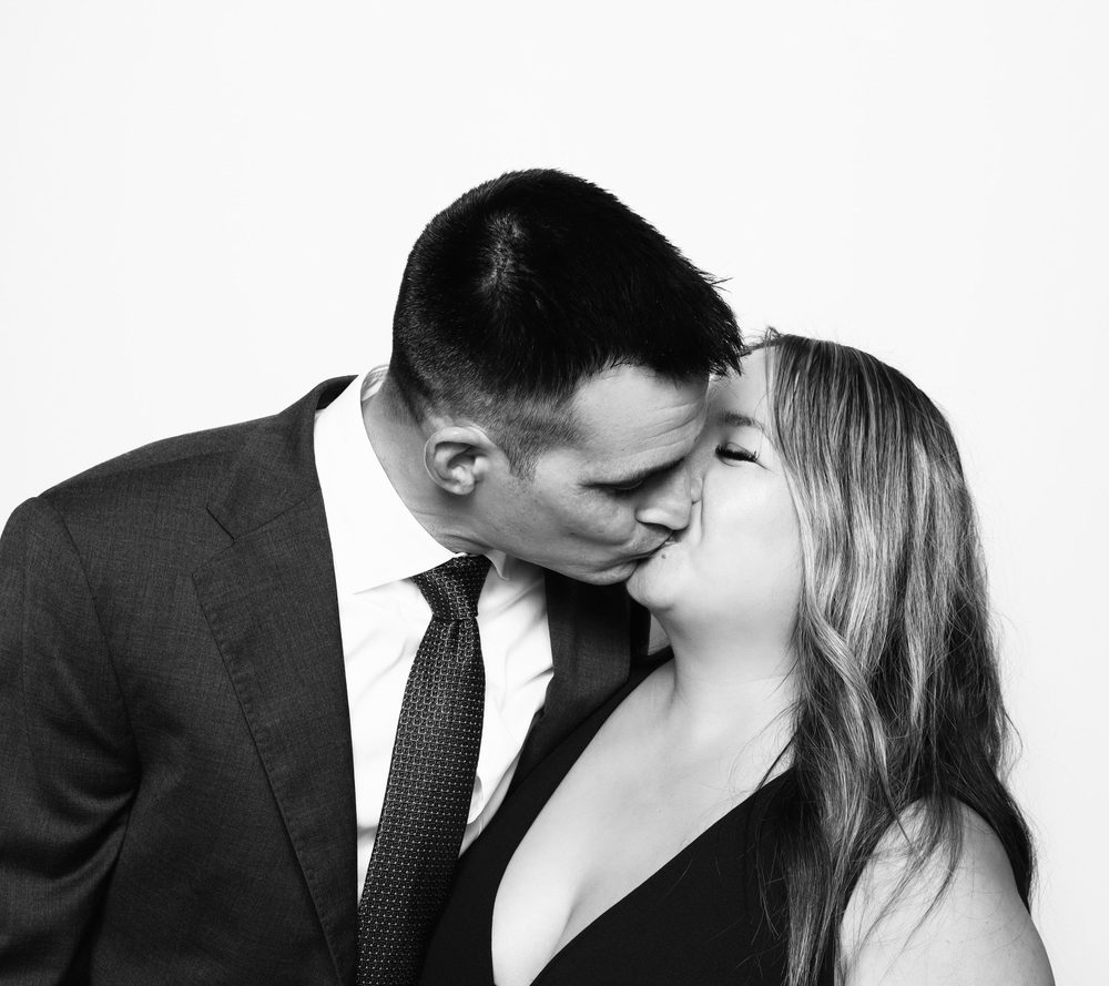 A couple kissing at an editorial wedding photo booth in Virginia Beach