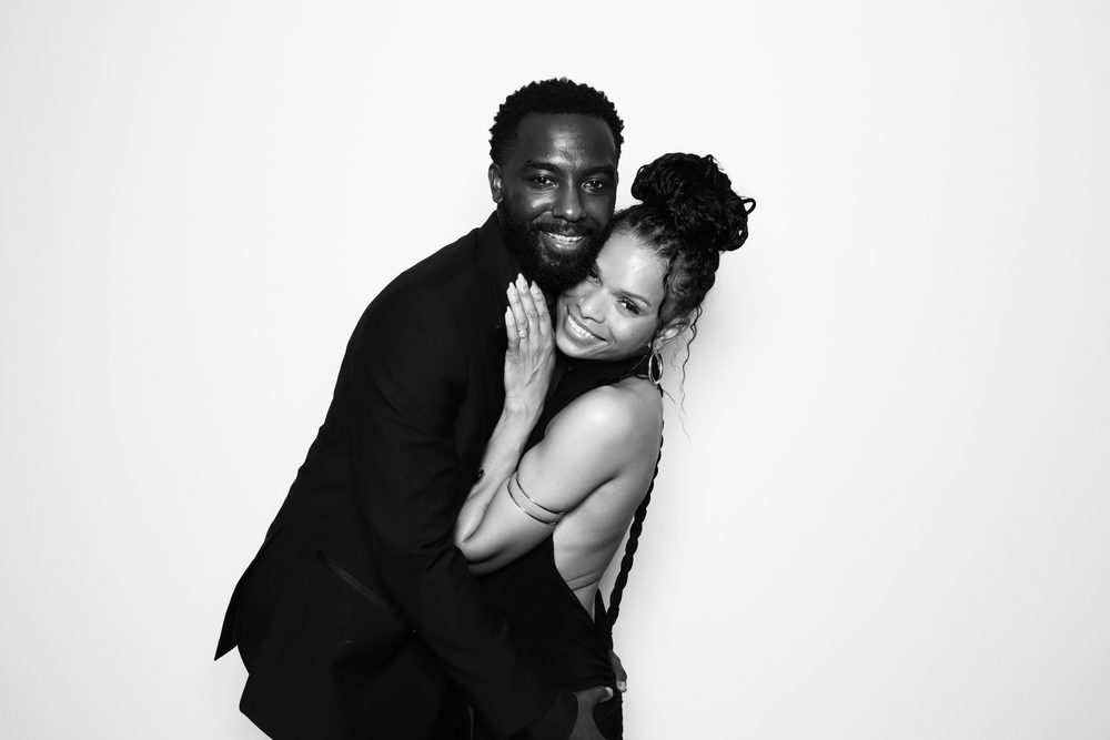 A guest couple in a playful embrace at a Chesapeake wedding reception photo booth