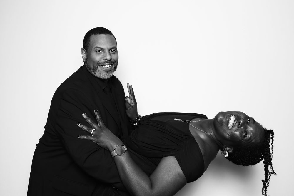A guest dipping his partner dramatically at a black-and-white wedding photo booth in Chesapeake