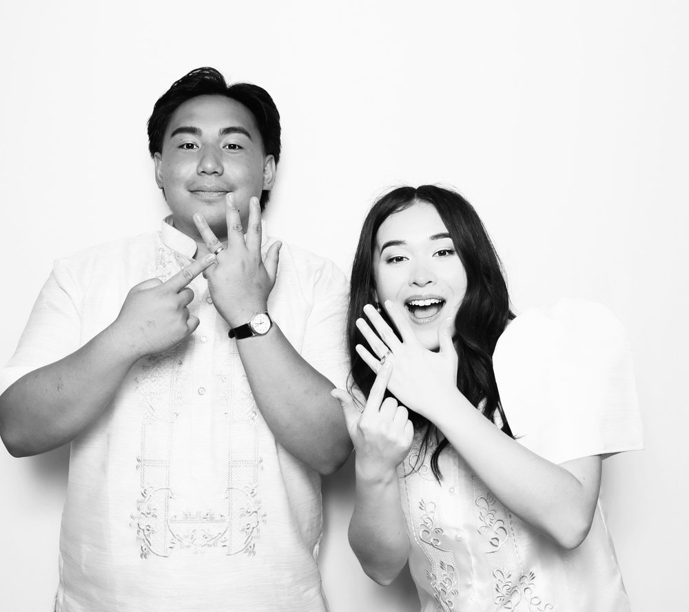 Malinnie and Patrick posing together at their black-and-white wedding photo booth in Virginia Beach