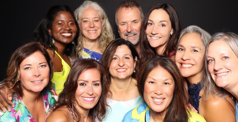 A group of ten friends smiling together at the FACT4Autism gala photo booth at The Dome in Virginia Beach